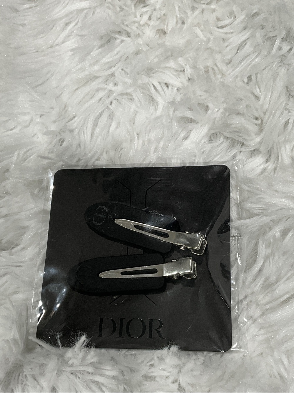 Dior Black and Silver Signature Hair Clips from an event